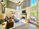 Inviting living room with vaulted ceilings, a cozy fireplace, ample natural light, and stylish, comfortable furnishings at 2870 Willow Wisp Way, Cumming, GA 30040