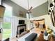 Bright living room featuring a cozy fireplace, comfortable seating, and views of the outdoors at 2870 Willow Wisp Way, Cumming, GA 30040
