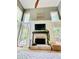Bright living room with a brick fireplace, high ceilings, and large windows, creating a cozy and inviting atmosphere at 2870 Willow Wisp Way, Cumming, GA 30040