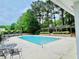Community pool featuring pristine water and poolside seating surrounded by lush greenery at 2870 Willow Wisp Way, Cumming, GA 30040