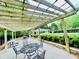 Pergola with tables overlooking a community pool and a cabana surrounded by greenery at 2870 Willow Wisp Way, Cumming, GA 30040