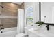 Well-lit bathroom features tile accents, a shower, and natural light at 2977 Treeside Ter, Marietta, GA 30066