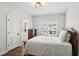 Bright bedroom features wood floors, white walls, and plantation shutters at 2977 Treeside Ter, Marietta, GA 30066