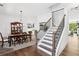 Charming dining room with a wooden dining table, staircase, and open view into the kitchen at 2977 Treeside Ter, Marietta, GA 30066