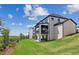 Backyard view of two-story home with multiple patios and landscaped lawn at 2977 Treeside Ter, Marietta, GA 30066