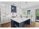 Bright kitchen with white cabinets, a blue island, quartz counters, and a stainless steel range at 2977 Treeside Ter, Marietta, GA 30066
