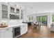 Elegant kitchen with white cabinets, wine storage, and a beverage fridge adjacent to the adjacent dining area at 2977 Treeside Ter, Marietta, GA 30066