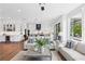 Open-concept living room with hardwood floors, sofas, and an adjacent kitchen with white cabinets at 2977 Treeside Ter, Marietta, GA 30066