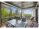 Outdoor patio with seating, a dining table, a grill, and a view of the surrounding trees at 2977 Treeside Ter, Marietta, GA 30066