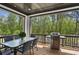 Spacious porch with a grill and outdoor dining area surrounded by lush greenery at 2977 Treeside Ter, Marietta, GA 30066