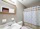 Modest bathroom featuring a clean, white toilet and sink with shower and curtain at 3844 Lake Se Dr, Smyrna, GA 30082