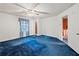 Spacious bedroom featuring blue carpeting, a window, and direct access to other rooms at 3844 Lake Se Dr, Smyrna, GA 30082