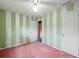 Bright bedroom with stripped green wallpaper and a ceiling fan at 3844 Lake Se Dr, Smyrna, GA 30082