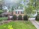 Charming two-story brick home featuring mature trees, a well-manicured lawn, and an attached two car garage at 3844 Lake Se Dr, Smyrna, GA 30082