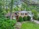 Two-story brick home with an attached garage, surrounded by lush landscaping at 3844 Lake Se Dr, Smyrna, GA 30082