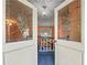 Foyer featuring decorative glass doors, blue carpet and staircase at 3844 Lake Se Dr, Smyrna, GA 30082