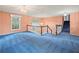 Spacious foyer with blue carpet, featuring staircase and upper windows at 3844 Lake Se Dr, Smyrna, GA 30082