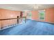 Blue carpeted foyer featuring decorative glass doors, staircase and upper windows at 3844 Lake Se Dr, Smyrna, GA 30082