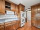 Traditional kitchen features wood cabinets, grey countertops, and stainless steel double oven at 3844 Lake Se Dr, Smyrna, GA 30082