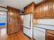 Galley kitchen featuring wooden cabinets, gray countertops, and modern white appliances at 3844 Lake Se Dr, Smyrna, GA 30082