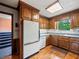 Kitchen featuring wood cabinets, granite countertops, and stainless steel appliances at 3844 Lake Se Dr, Smyrna, GA 30082