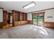 Living room features built-in wood shelving, carpet floors, and sliding glass door at 3844 Lake Se Dr, Smyrna, GA 30082