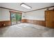 Spacious living room features carpet floors, natural lighting, and a sliding glass door at 3844 Lake Se Dr, Smyrna, GA 30082
