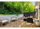 Landscaped backyard with patio furniture and view of hillside at 5250 Chemin De Vie, Atlanta, GA 30342