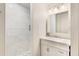 Bright bathroom features white tiled walls, a glass shower, and a modern vanity with a marble countertop at 5250 Chemin De Vie, Atlanta, GA 30342