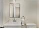 Cozy half bathroom with a white vanity, a modern mirror, and a toilet creating a clean and functional space at 5250 Chemin De Vie, Atlanta, GA 30342