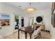 Bright dining room featuring stylish decor, wood floors, and double doors to an outdoor patio at 5250 Chemin De Vie, Atlanta, GA 30342
