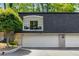 Exterior of home with a white garage door and a deck on the second story at 5250 Chemin De Vie, Atlanta, GA 30342