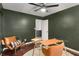 Charming home office features dark green walls, a glass desk, and lots of natural light at 5250 Chemin De Vie, Atlanta, GA 30342