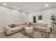 Comfortable living room featuring a large sectional sofa, wood floors, and sliding doors to an outdoor patio at 5250 Chemin De Vie, Atlanta, GA 30342