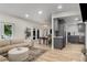 A bright open-concept living area features wood floors, a modern couch, and an open view into the dining and kitchen spaces at 5250 Chemin De Vie, Atlanta, GA 30342