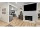 Spacious living room showcasing wood floors, a fireplace, and an open-concept design leading into the kitchen at 5250 Chemin De Vie, Atlanta, GA 30342