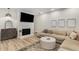 Inviting living room featuring a comfortable sectional sofa, a decorative fireplace, and hardwood flooring at 5250 Chemin De Vie, Atlanta, GA 30342
