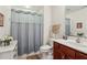 Bathroom with a shower/tub combo, vanity, and soft-colored curtain for privacy at 6103 Menlow Ct, Cumming, GA 30041