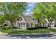 Well-maintained home exterior with stone accents, lush landscaping, and inviting curb appeal at 6103 Menlow Ct, Cumming, GA 30041