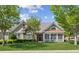 Charming home featuring a well-manicured lawn, stone accents, and a welcoming front porch at 6103 Menlow Ct, Cumming, GA 30041