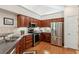 Bright kitchen with stainless steel appliances, plenty of counter space, and dark wood cabinets at 6103 Menlow Ct, Cumming, GA 30041