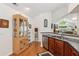 View of kitchen area leading to a living room, hardwood floors, and stainless steel dishwasher at 6103 Menlow Ct, Cumming, GA 30041