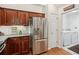 This updated kitchen has stainless steel appliances, dark wood cabinets, and a laundry room nearby at 6103 Menlow Ct, Cumming, GA 30041