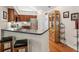 This kitchen features a breakfast bar, stainless steel appliances, and hardwood floors at 6103 Menlow Ct, Cumming, GA 30041