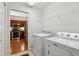Laundry room with washer, dryer, and adjacent kitchen for added convenience at 6103 Menlow Ct, Cumming, GA 30041