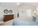 Bright main bedroom features a ceiling fan, wood dresser, and tree decorations at 6103 Menlow Ct, Cumming, GA 30041