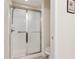 Tiled shower with glass doors and a built-in soap dish for convenience at 6103 Menlow Ct, Cumming, GA 30041