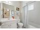 Bright bathroom featuring white fixtures, tile, and a shower with a curtain at 104 Glentown Way, Sandy Springs, GA 30328