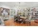 Elegant dining room with hardwood floors, custom bookshelves, and stylish decor at 104 Glentown Way, Sandy Springs, GA 30328