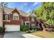 Charming brick home with manicured lawn, two-car garage, and inviting curb appeal at 104 Glentown Way, Sandy Springs, GA 30328